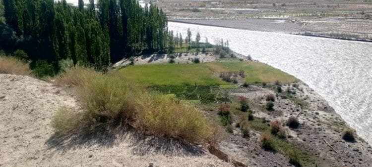 Flooded Yarkhun River eroding farmland in Birzoz village, Upper Chitral.