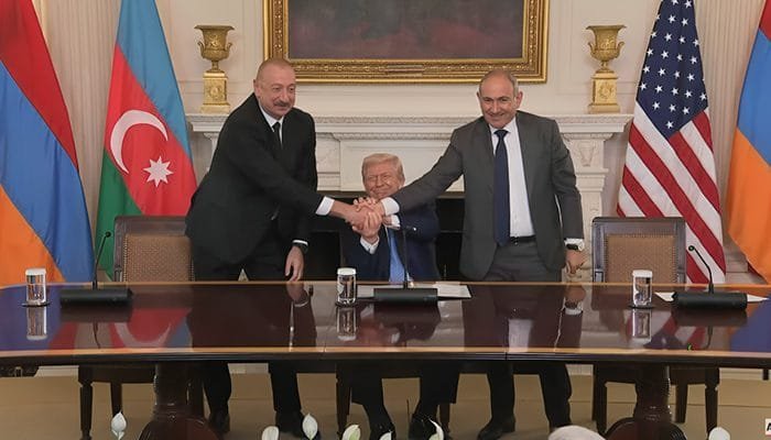 Azerbaijan and Armenia leaders shake hands after signing a peace deal brokered by Donald Trump in Washing.