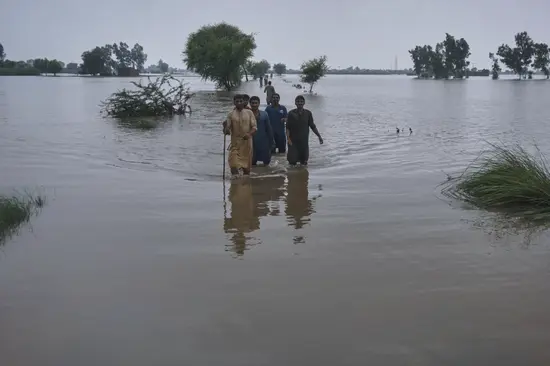 People seen stranded in a village in Punjab after flooding in rivers.