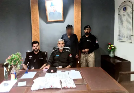 Lower Chitral police officials with a man from Mohmand after his arrest with over one kg opium.