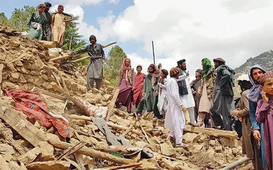 People gather at a building turned into rubble in an earthquake that hit eastern Afghanistan on the night of Aug 31, 2025.