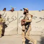 Afghan security forces guard a post along their border with Pakistan.