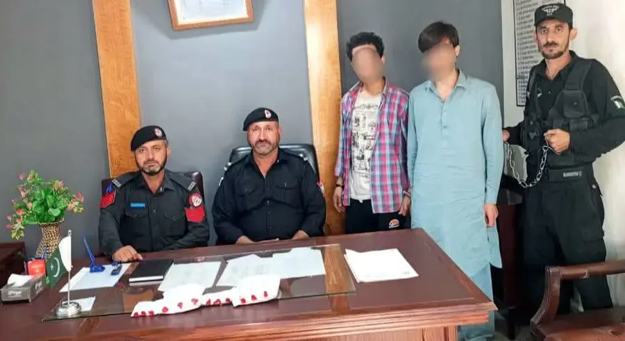 Chitral police officials pictured with two young men after their arrest in separate operations after recovery of narcotics.