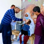‎Deputy Commissioner Muhammad Imran Khan administers drops to a child in Booni to formally launch a campaign in Upper Chitral, Oct 9, 2025.