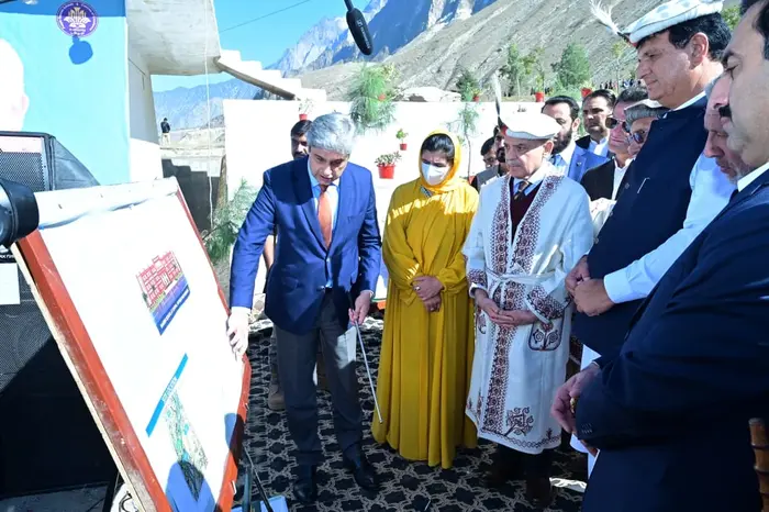Prime Minister Shehbaz Sharif surrounded by federal ministers and bureaucrats during Chitral visit.