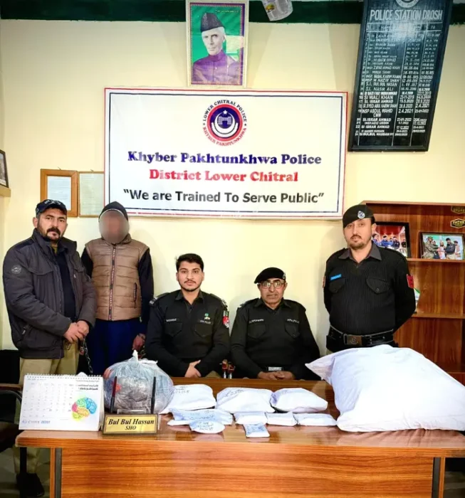 Drosh police officials with a man they arrested with stolen goods from a house.