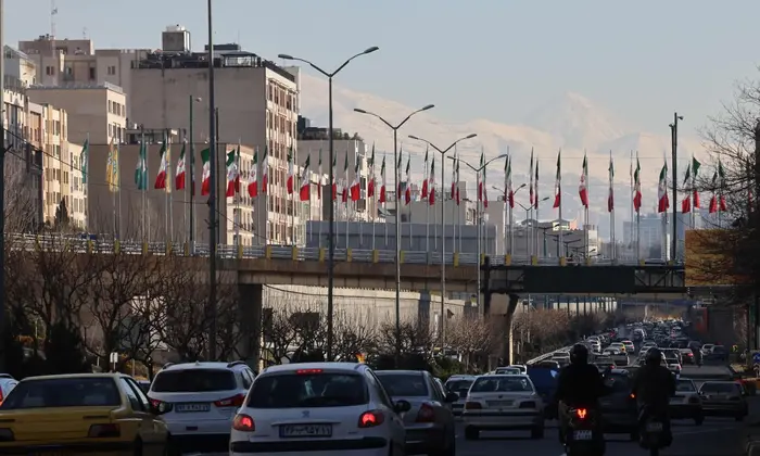 view of highway traffic west of Tehran towards the summit of Mount Damavand.