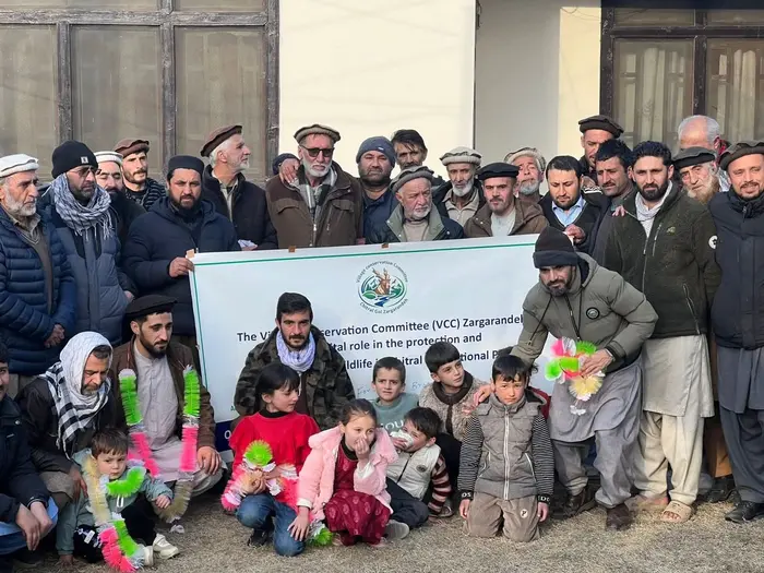 Afghan families pose for a picture before their departure for their country from Zargarandeh in Chitral, Feb 3, 2026.