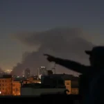 Smoke rises from a building in Iran after airstrikes by US.