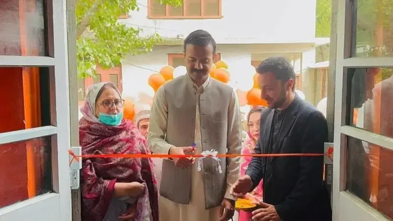 Lower Chitral DC Rao Hashim Azam and District Welfare Officer Khizar Hayat cut a ribbon to inaugurate women desk.