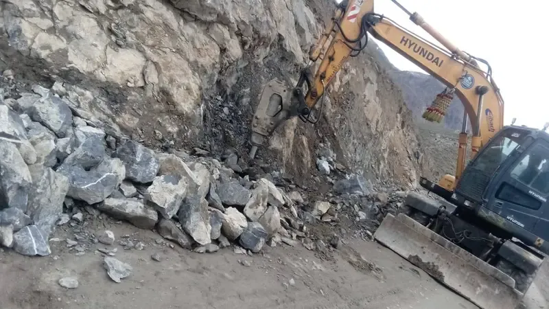 Workers busy removing debris from Booni-Buzund road in Upper Chitral.