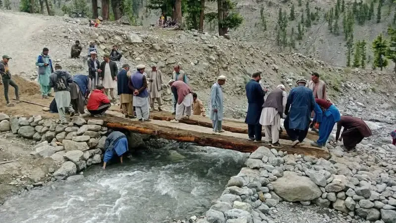 Ismailis of Madaklasht in Lower Chitral construct a bridge over river to facilitate people during Didar in Garam Chashma.
