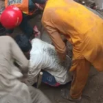 Rescue workers at a tuition centre in Lahore where roof collapse killed 14 children.