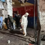 Officials collect evidence after suicide explosion outside Kabal police station in Swat.