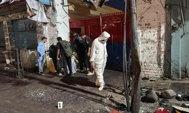 Officials collect evidence after suicide explosion outside Kabal police station in Swat.