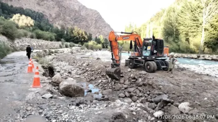 NHA machinery seen clearing flood debris from Garam Chashma road in Lower Chitral, Aug 12, 2026.